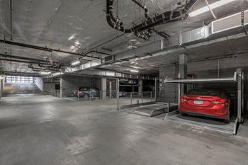 a red car parked in a parking garage at The Parker Apartments, Portland, Oregon
